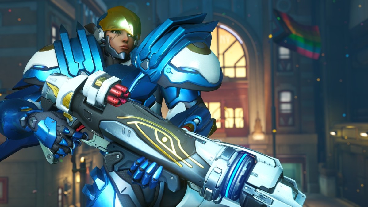 Overwatch 2 character Pharah posing with an LGBTQ+ progress flag in the background